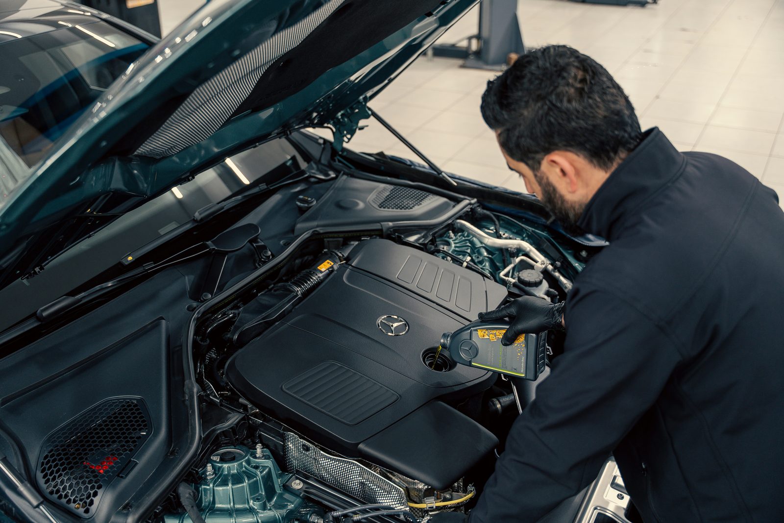 A mechanic at work on a vehicle in the Teddy Auto Services shop